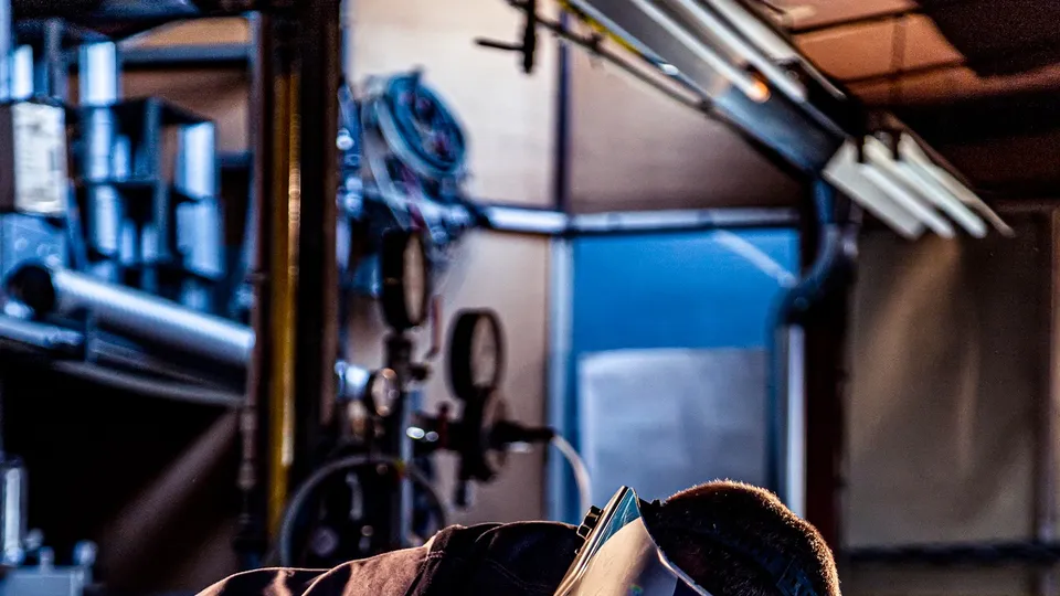 A welder at work with sparks flying