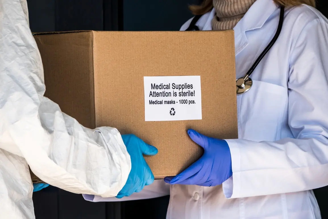 A gloved courier holding a medicine parcel