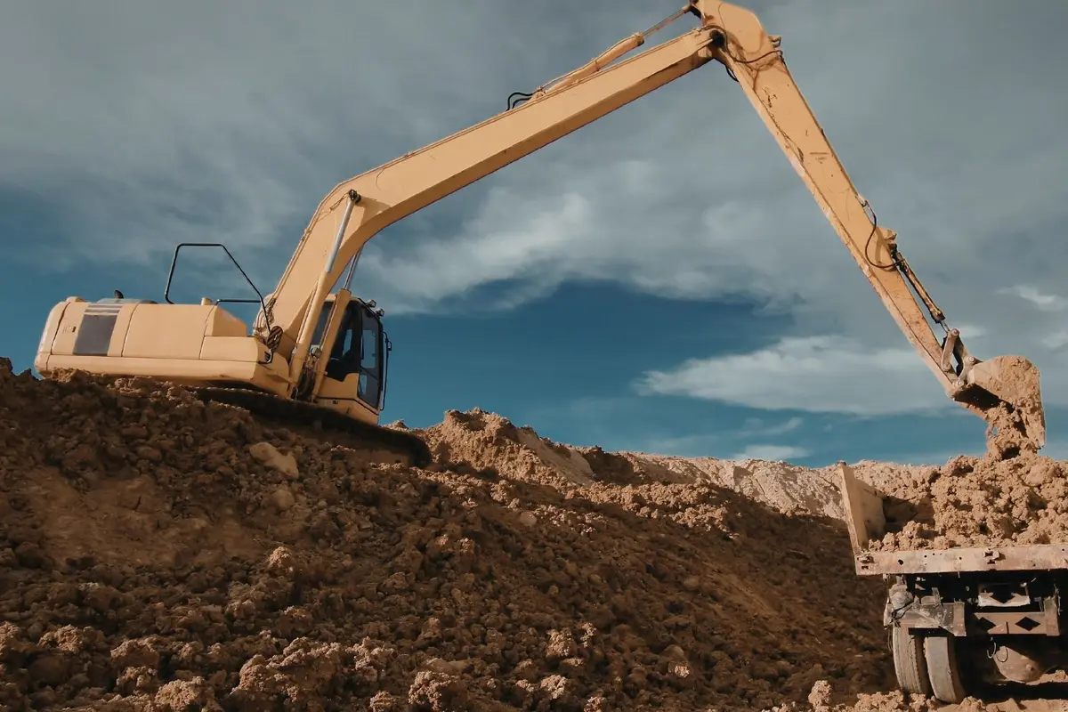 An excavator loading a truck