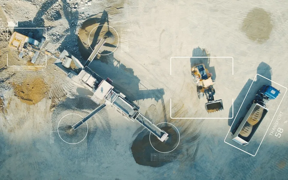Aerial view of an excavator and machines on a site with tracking frames
