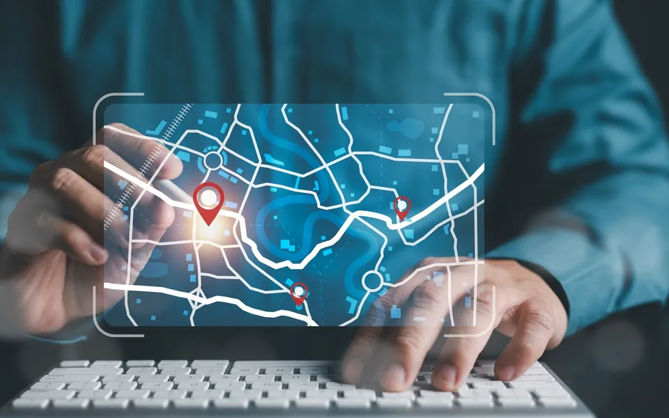 Hands on a laptop with a glowing route map